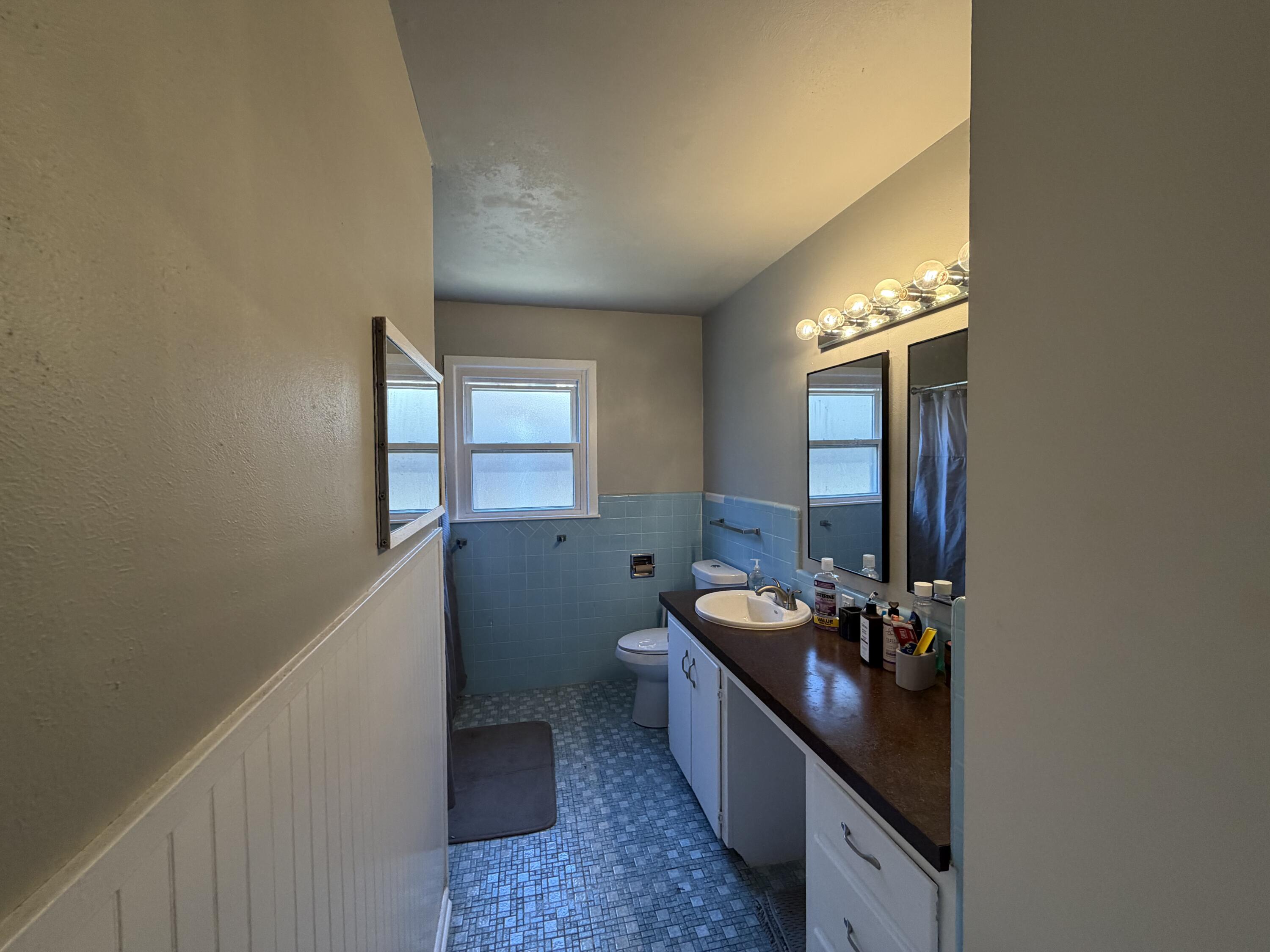 2202 58th Street Lubbock, TX 79412 - Photo 29 of 37 a bathroom with a double vanity sink and a mirror