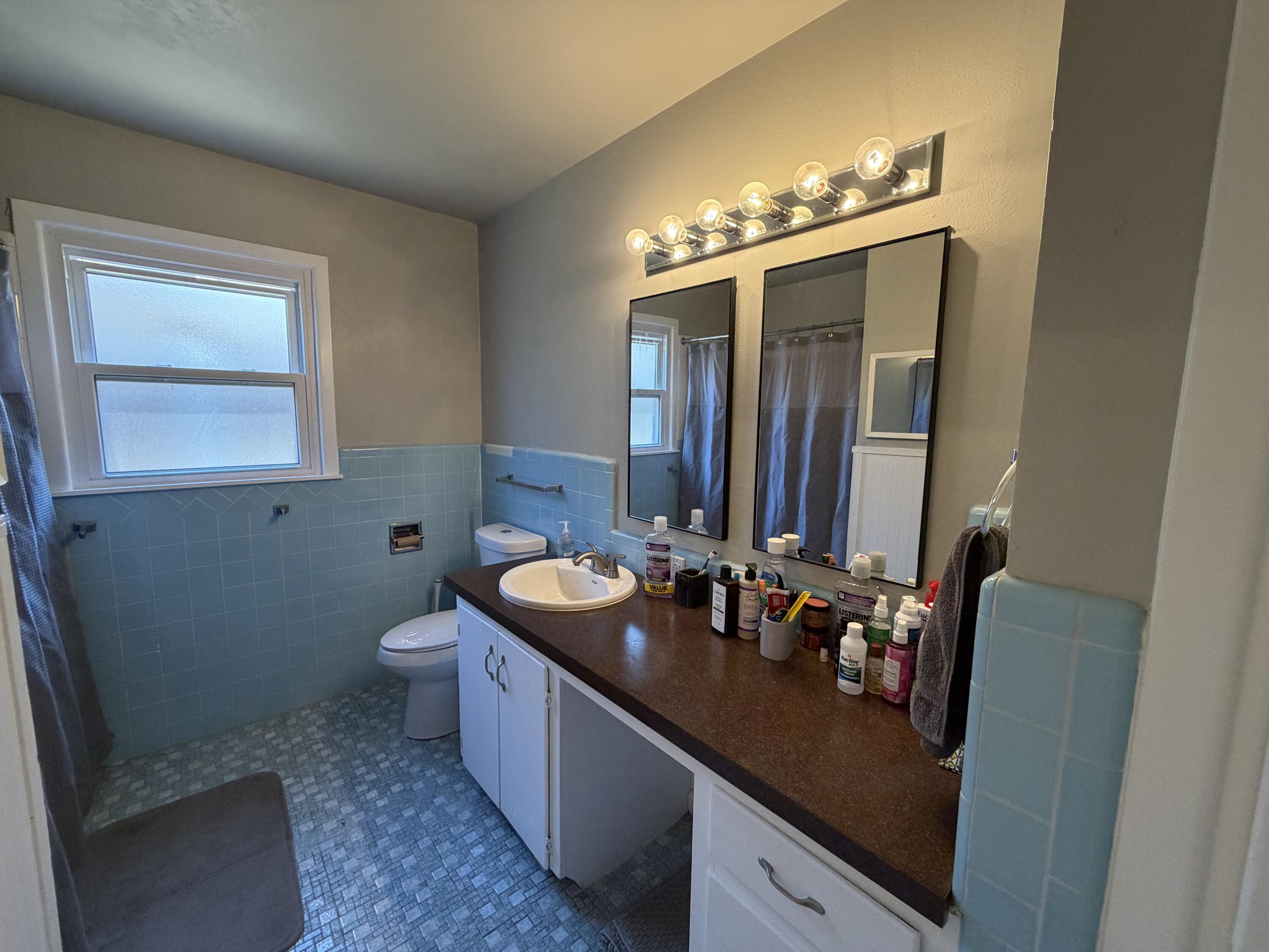 2202 58th Street Lubbock, TX 79412 - Photo 30 of 37 a bathroom with a sink double vanity and a mirror
