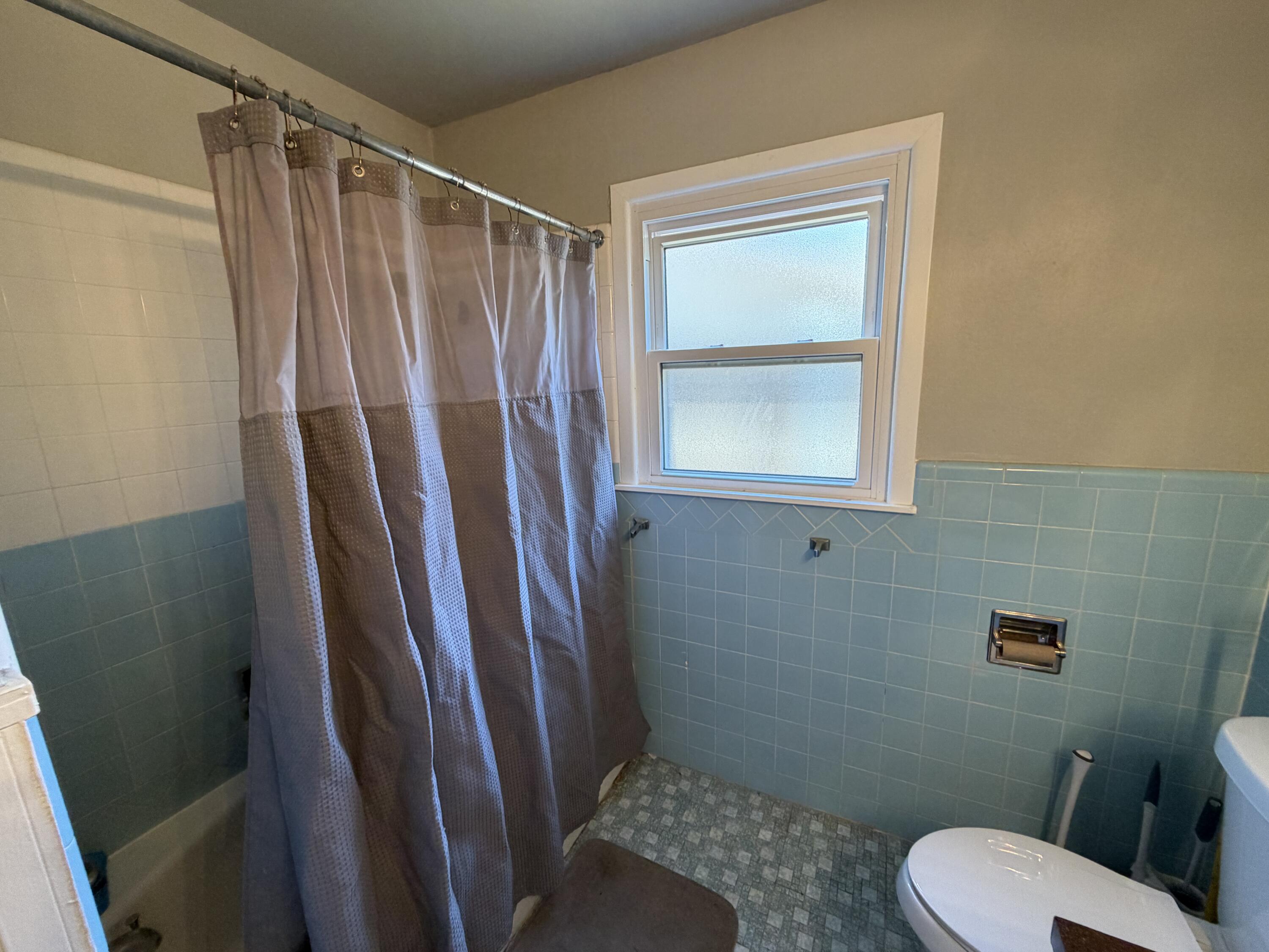2202 58th Street Lubbock, TX 79412 - Photo 31 of 37 a bathroom with a toilet and a shower
