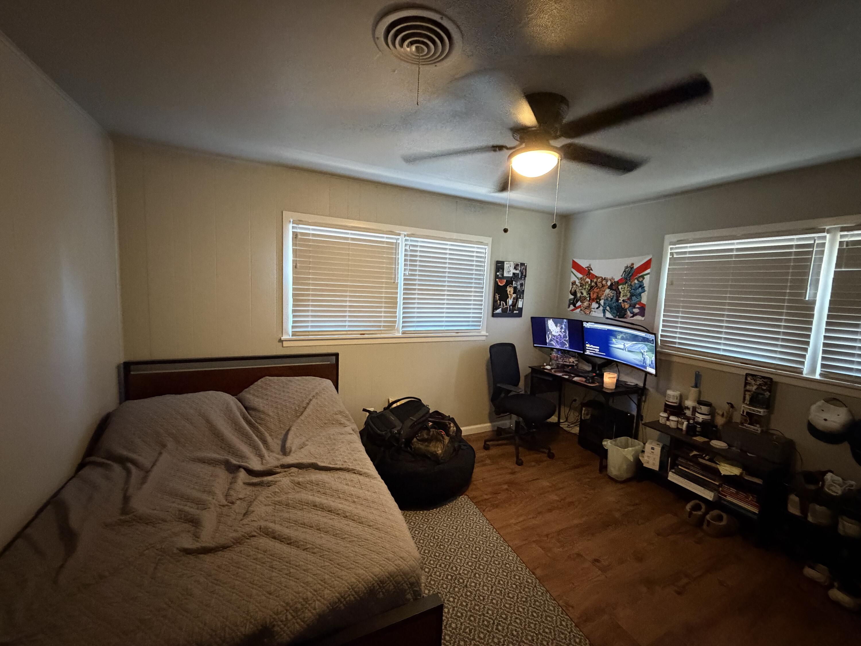 2202 58th Street Lubbock, TX 79412 - Photo 32 of 37 a bedroom with bed and a chandelier