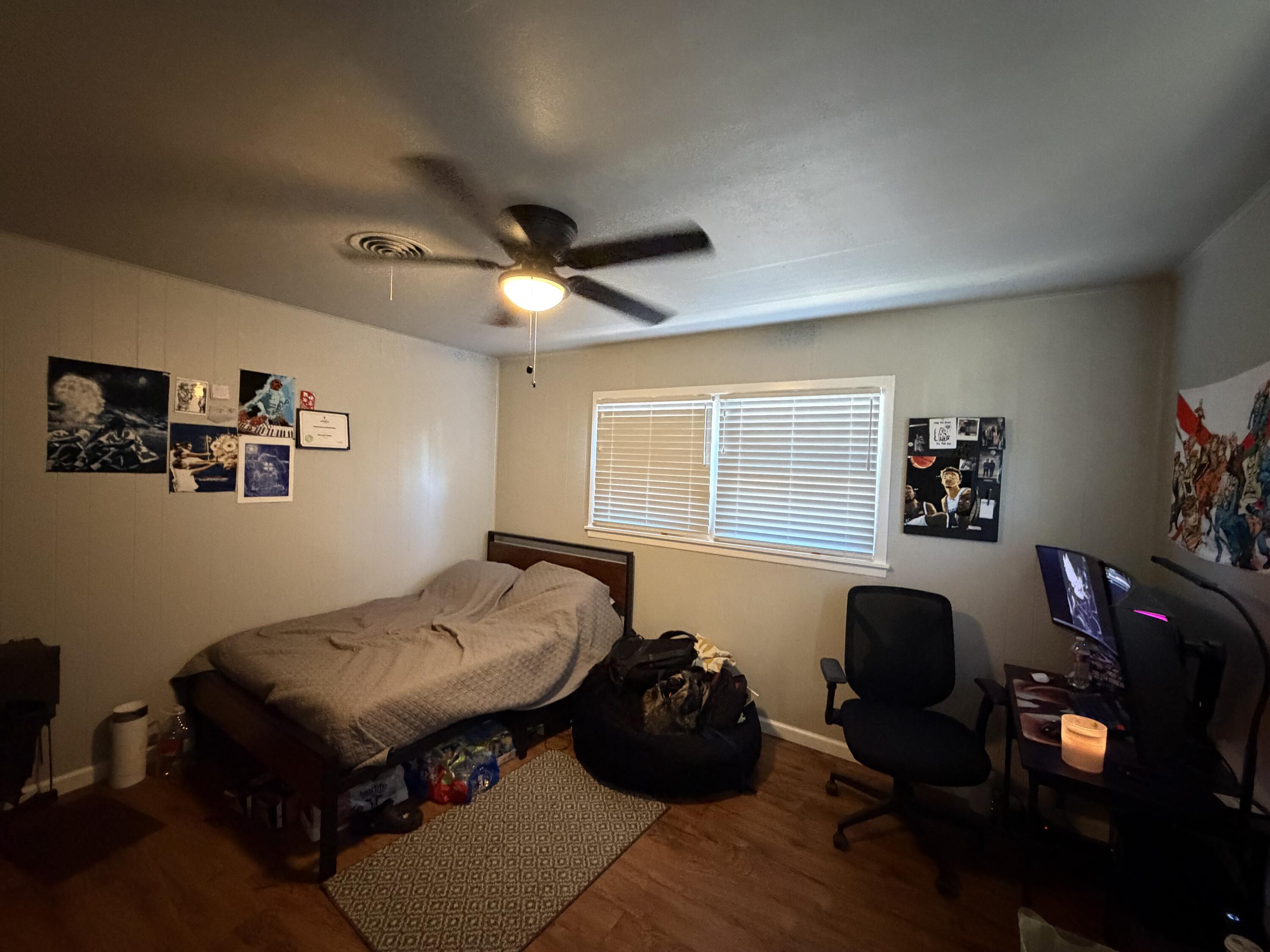 2202 58th Street Lubbock, TX 79412 - Photo 33 of 37 a bedroom with a bed and wooden floor