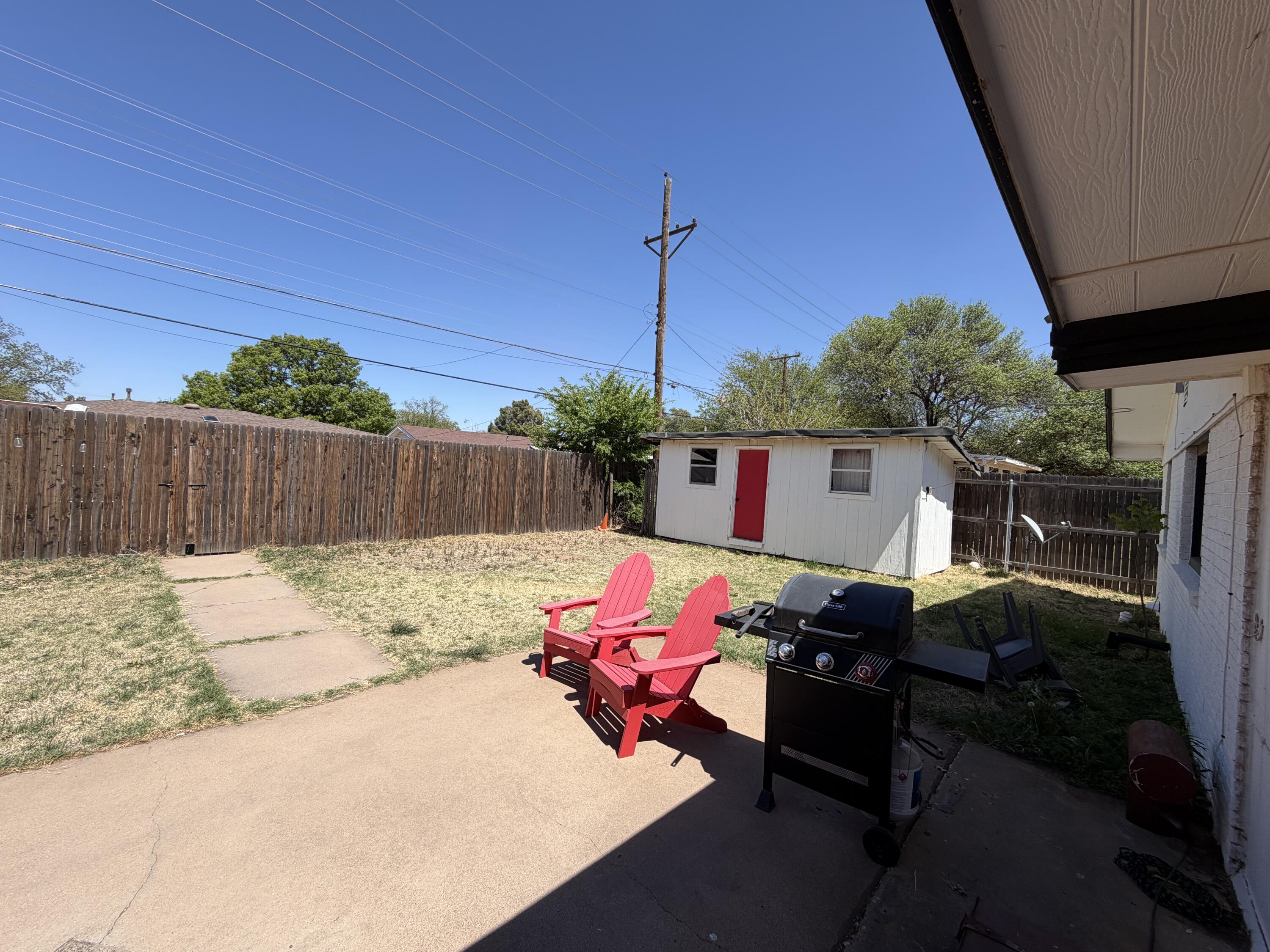 2202 58th Street Lubbock, TX 79412 - Photo 35 of 37 a backyard of a house with yard fire pit and outdoor seating