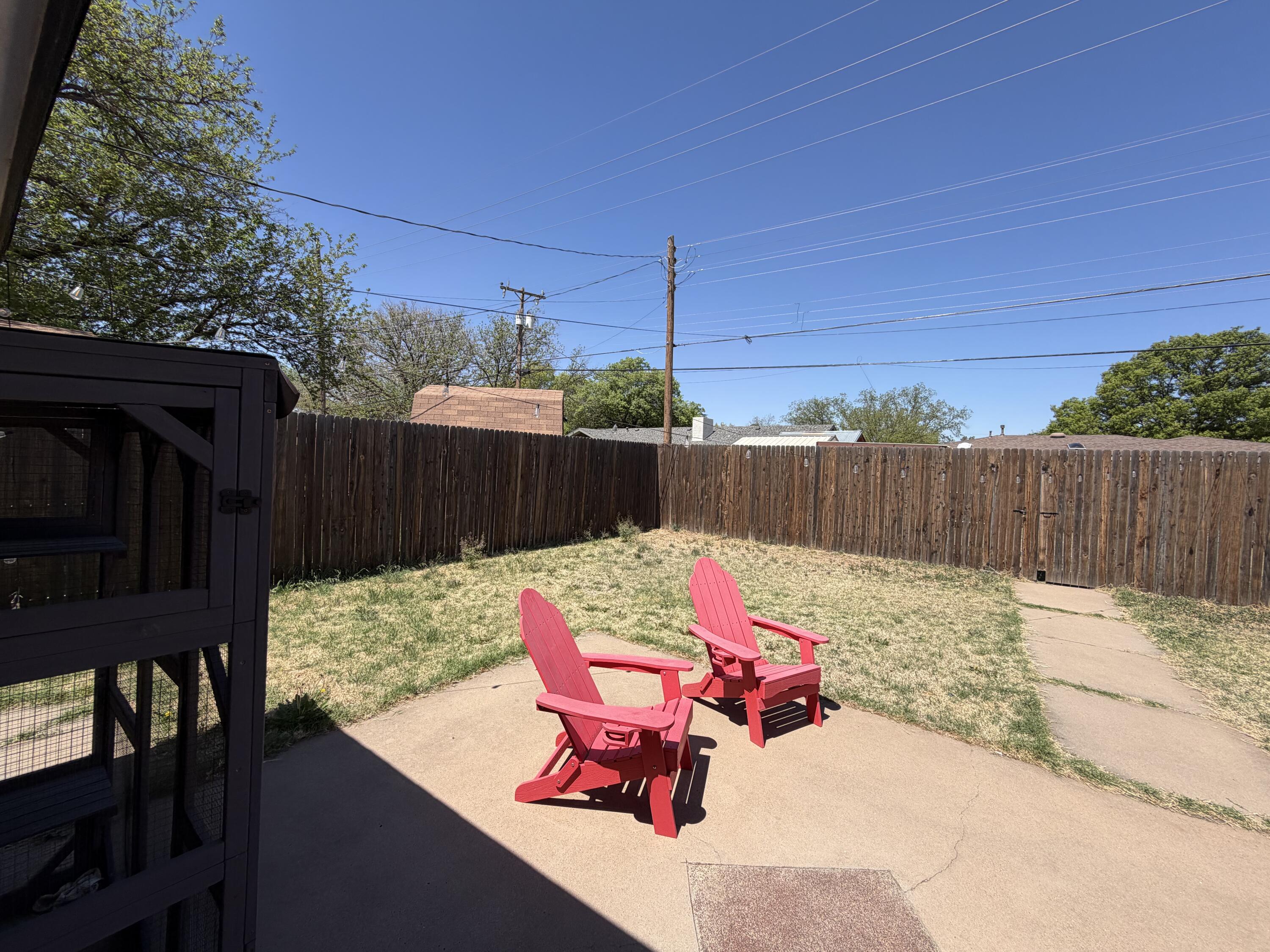 2202 58th Street Lubbock, TX 79412 - Photo 36 of 37 a backyard of a house with table and chairs