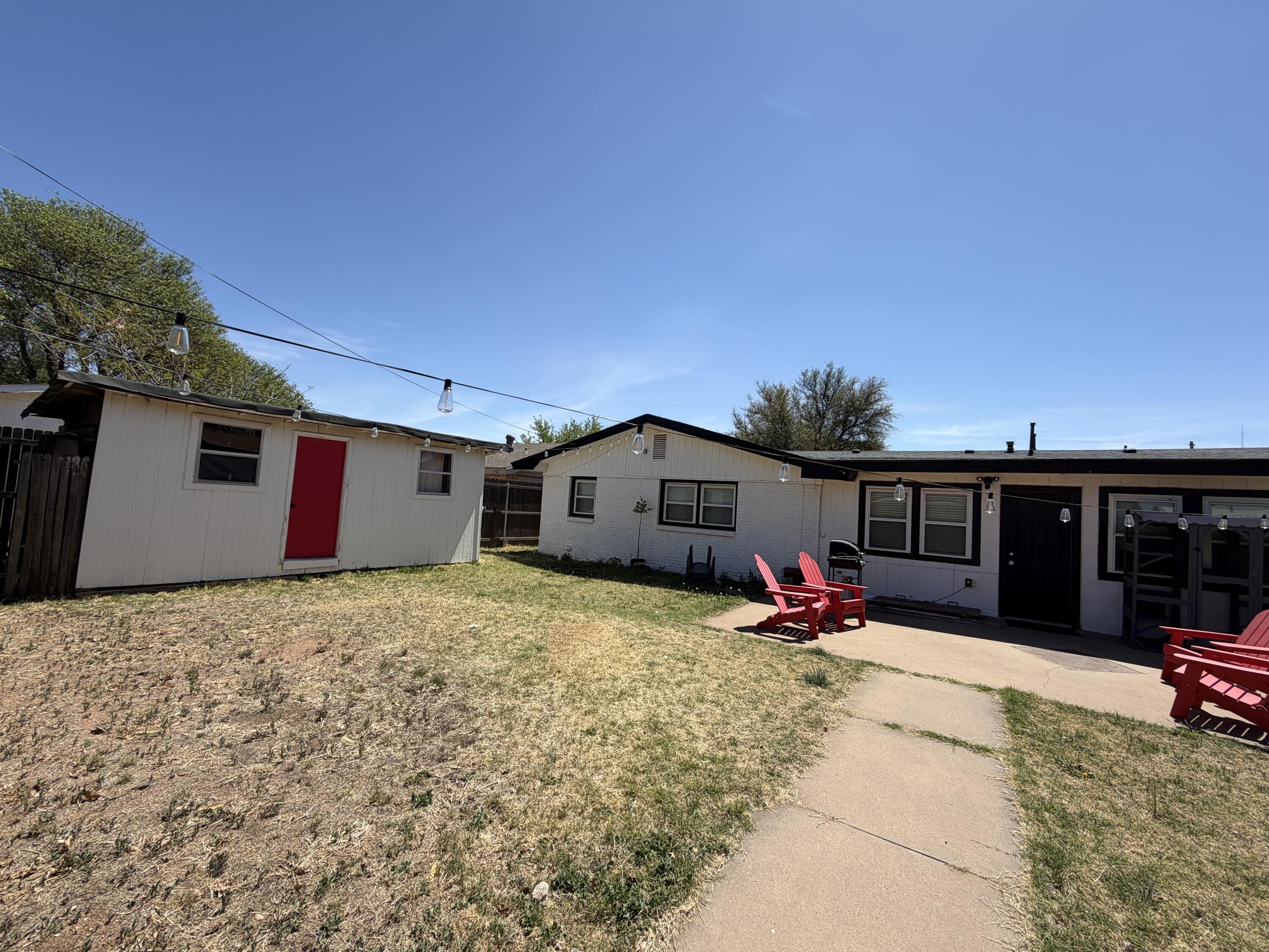 2202 58th Street Lubbock, TX 79412 - Photo 37 of 37 a backyard of a house with table and chairs