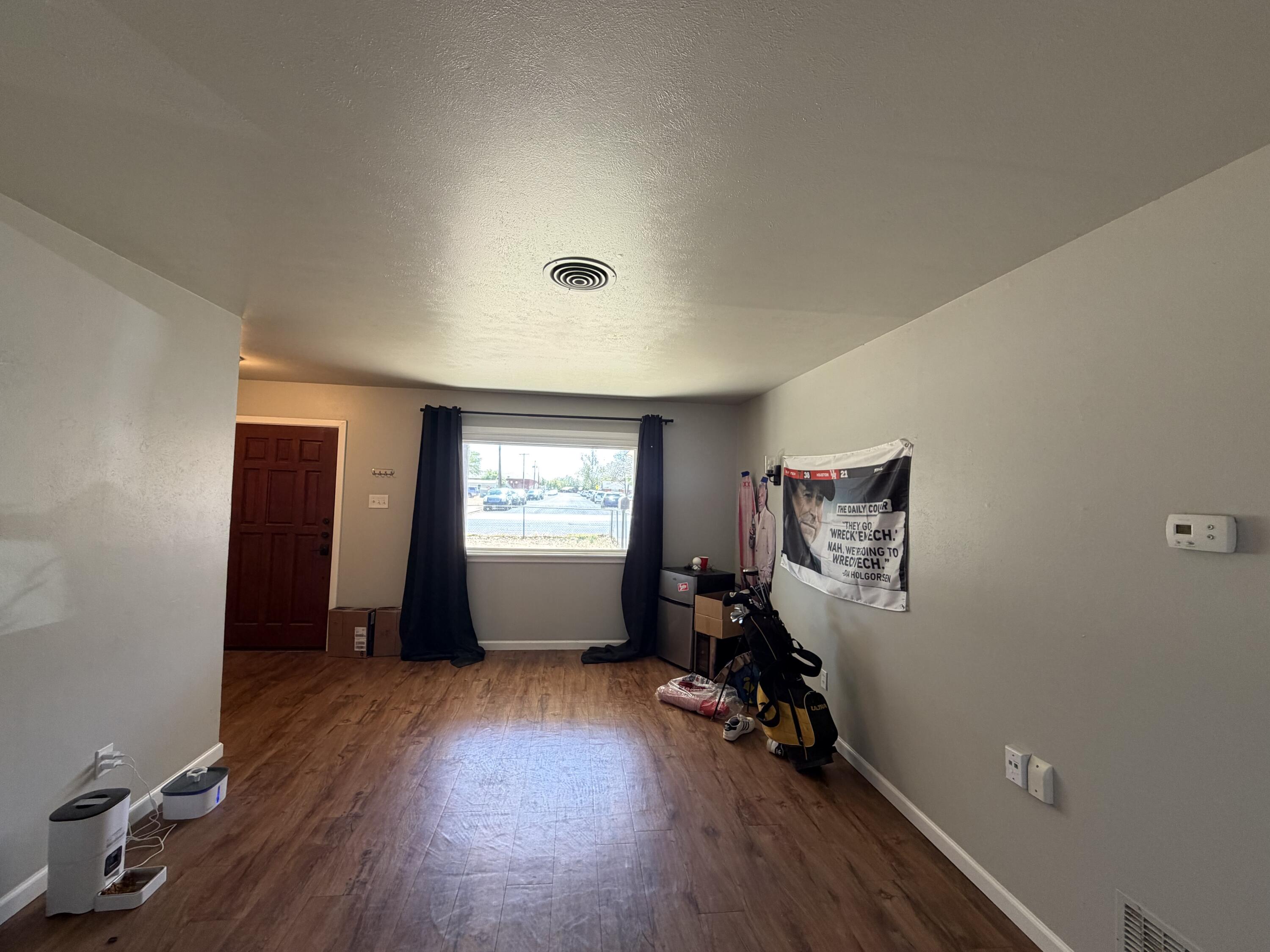 2202 58th Street Lubbock, TX 79412 - Photo 6 of 37 an empty room with closet and wooden floor