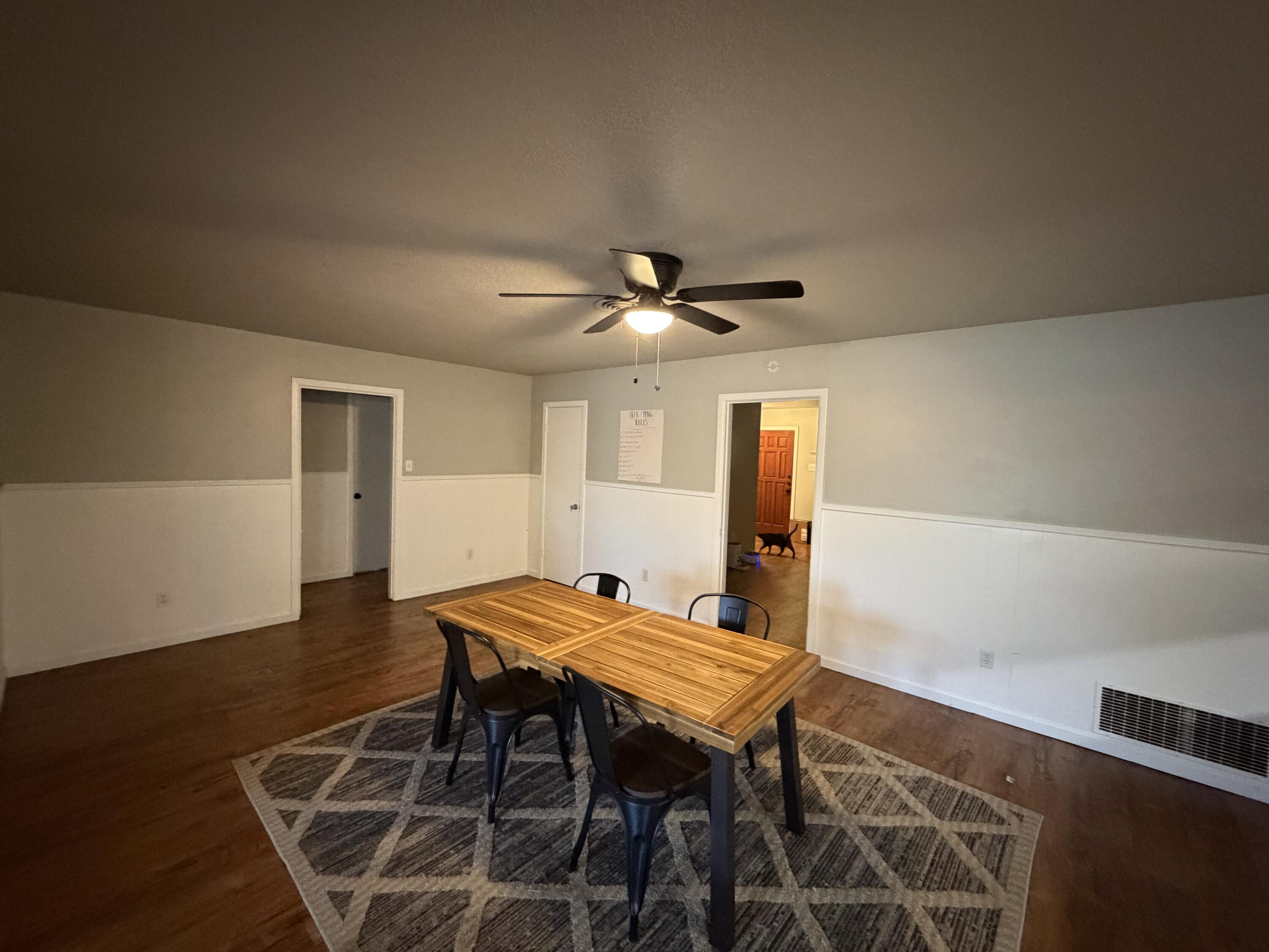 2202 58th Street Lubbock, TX 79412 - Photo 7 of 37 a view of a dining room with furniture and wooden floor