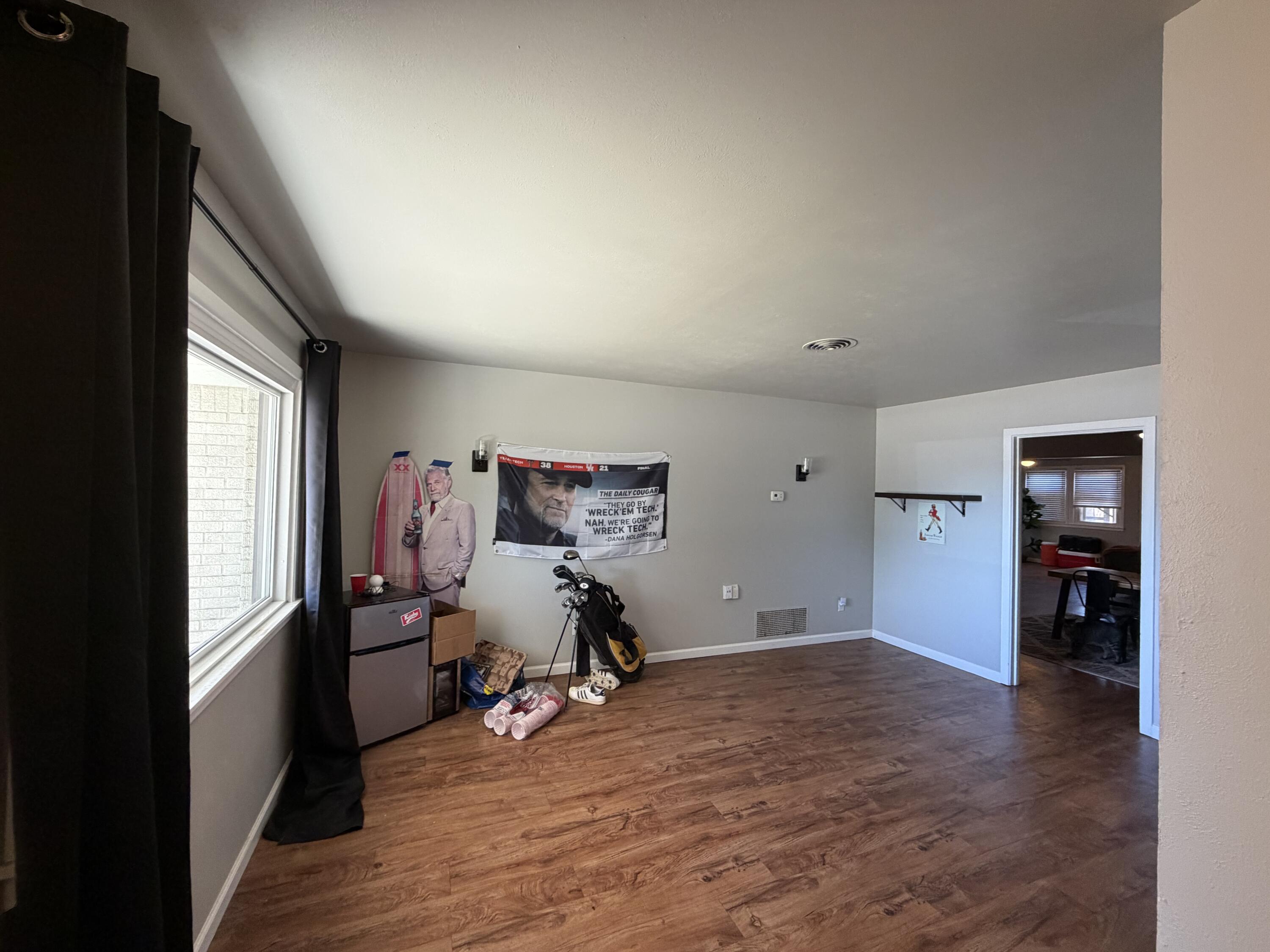 2202 58th Street Lubbock, TX 79412 - Photo 10 of 37 a view of a workspace with furniture and a window