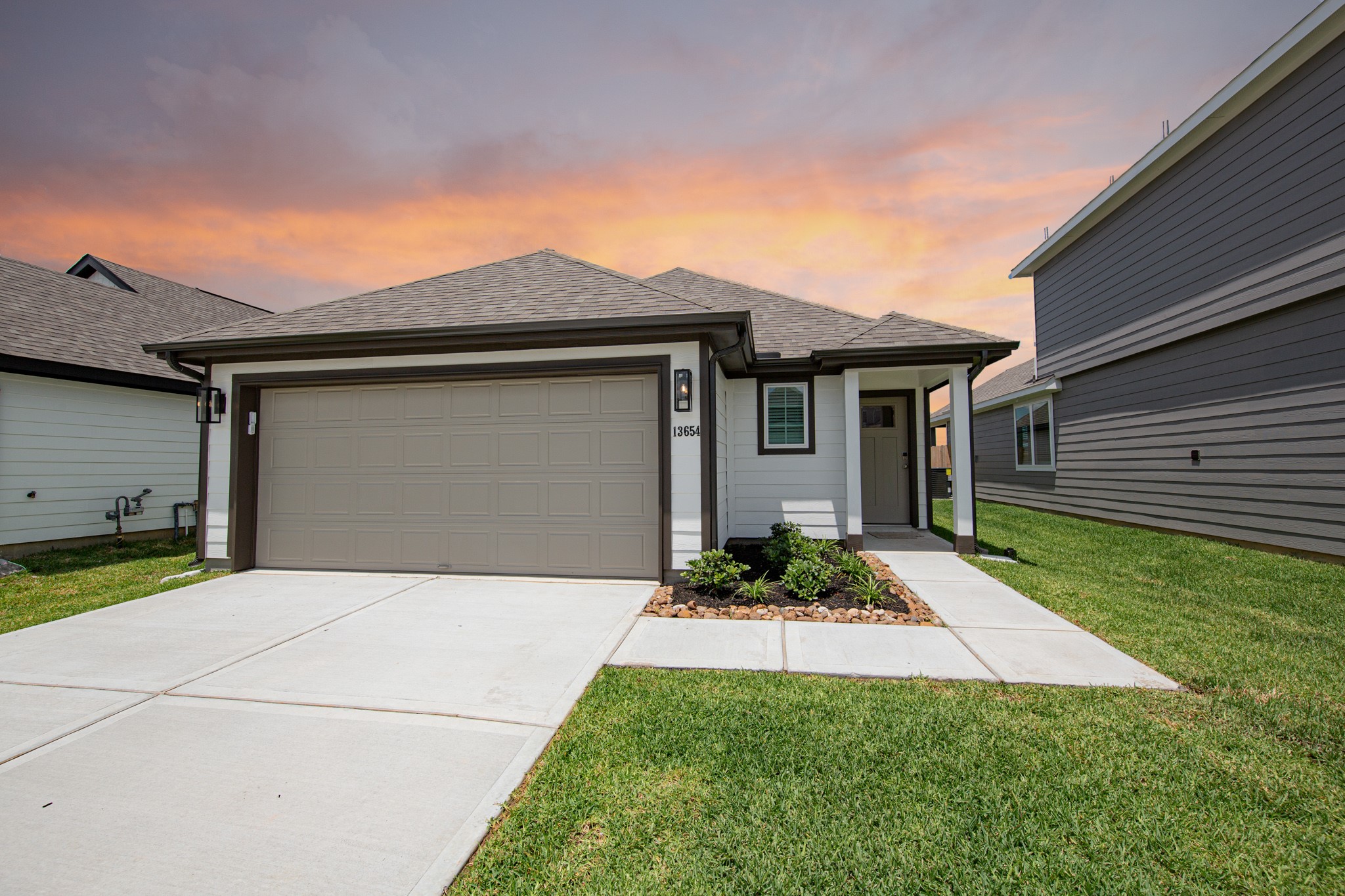 13654 Kit Run Splendora, TX 77372 - Photo 1 of 24 a front view of a house with a yard and garage