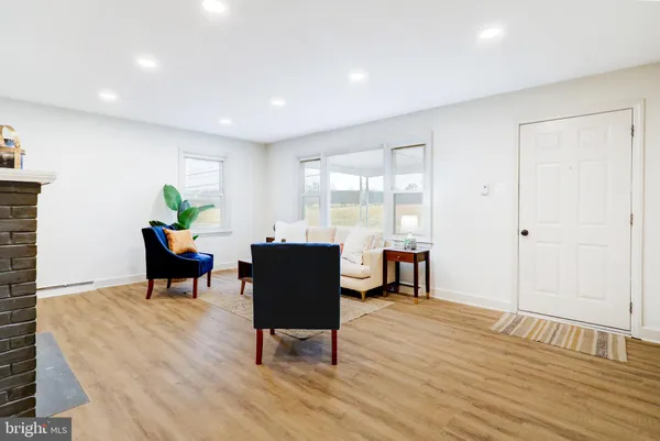 a view of a dining room with a table and chairs