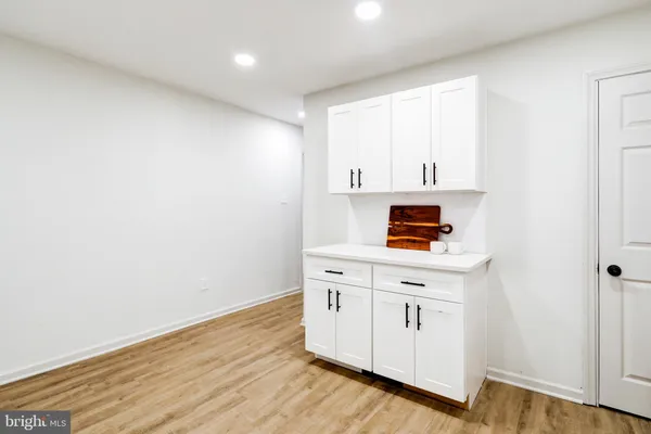 a view of cabinets with wooden floor and window