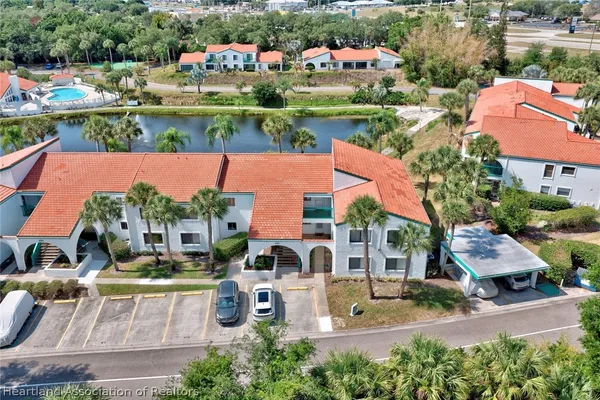 an aerial view of multiple houses with yard