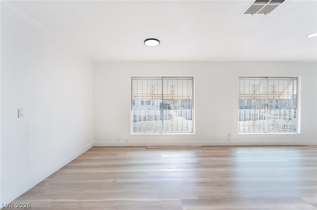 4980 Ridge Drive Las Vegas, NV 89103 - Photo 9 of 36 Spare room featuring light wood-type flooring and baseboards