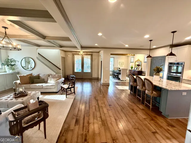 a kitchen with stainless steel appliances granite countertop a refrigerator a stove a sink and a microwave