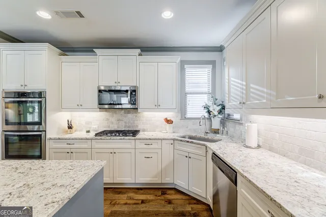 a close view of a stove a microwave and cabinets in the kitchen