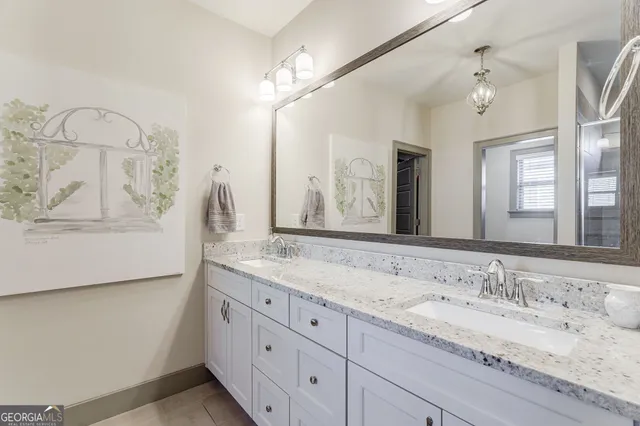 a bedroom with a bed and a flat tv screen on dresser