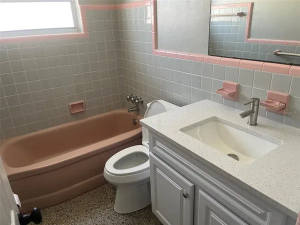 a bathroom with a sink a toilet and bathtub