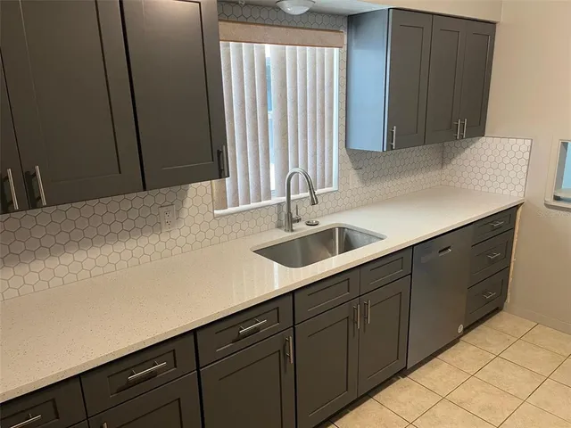 a kitchen with a refrigerator and a stove