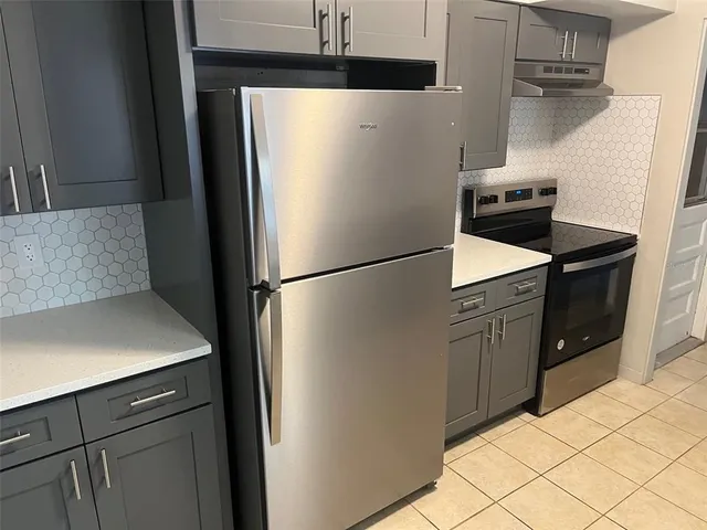 a kitchen with a sink and wooden cabinets