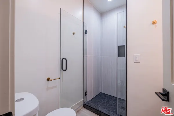 a bathroom with a shower toilet and sink