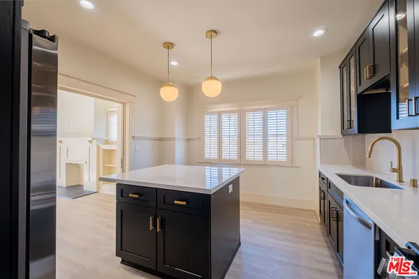 a kitchen with a stove a sink and a refrigerator