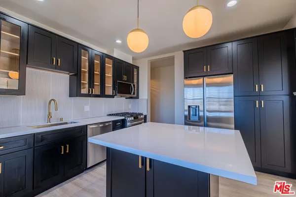 a kitchen with a sink cabinets and window
