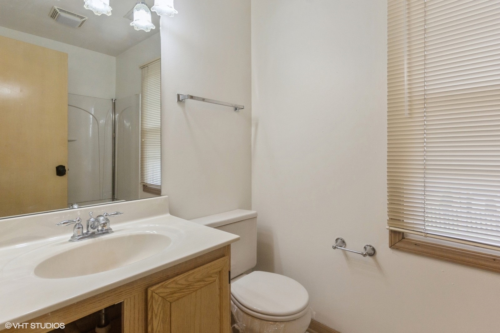 4418 Riverside Drive Plainfield, IL 60586 - Photo 14 of 21 a bathroom with a toilet a sink a mirror and vanity