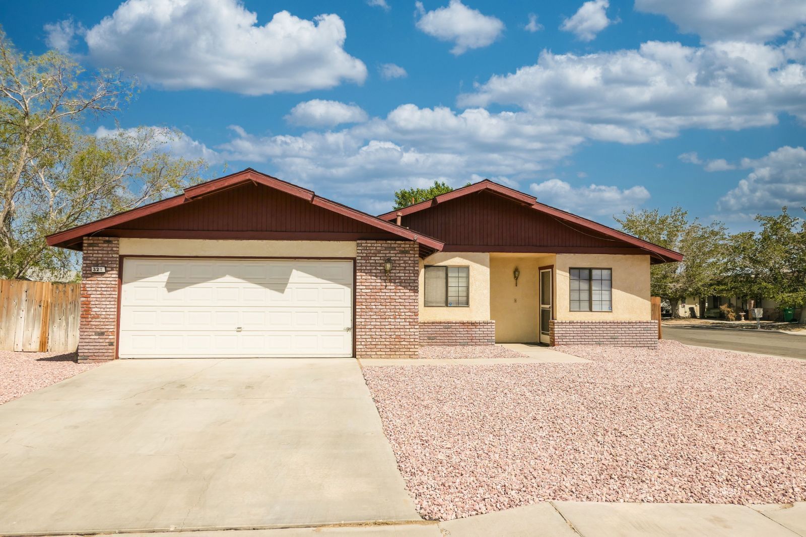 322 Reese Street Ridgecrest, CA 93555 - Photo 1 of 35 a front view of a house with a yard and garage