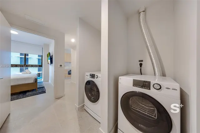 a view of storage and utility room with washer and dryer