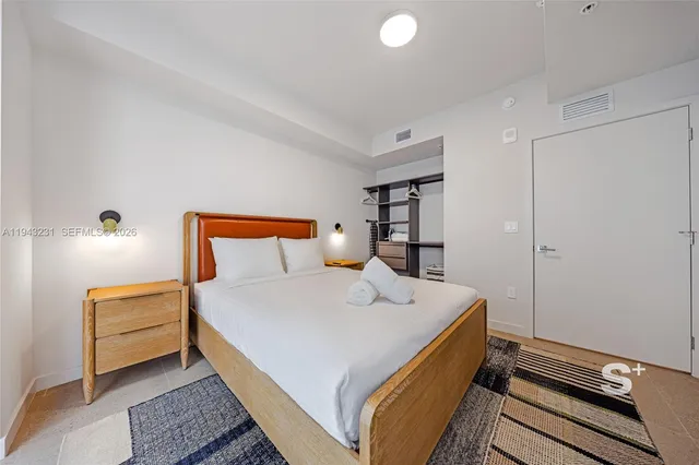 a bedroom with a bed and a night stand