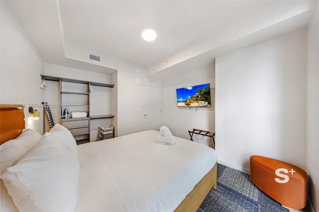 a bedroom with a bed and a view of bathroom