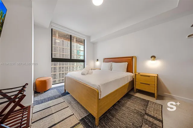 a bedroom with a bed and window