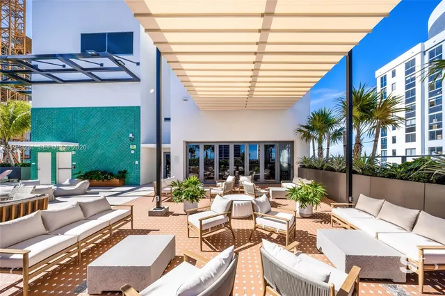a view of a patio with chairs and tables