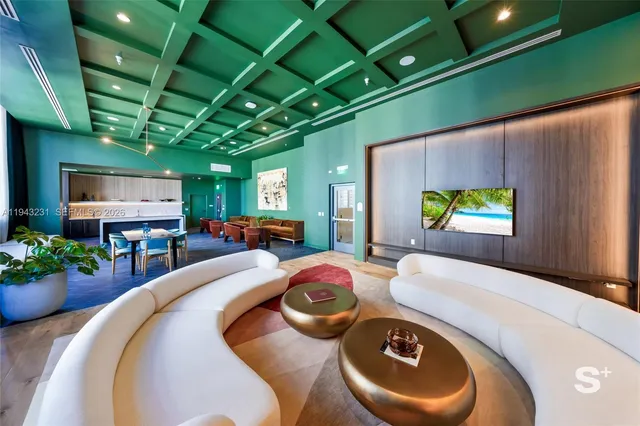 a swimming pool with dining table and chairs in front of it