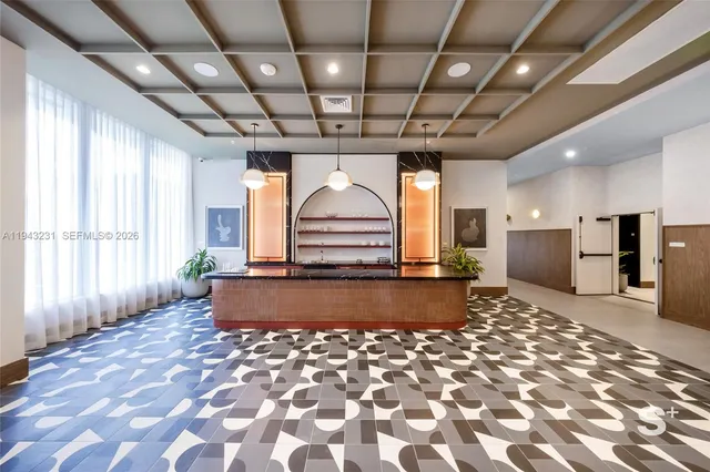 a large hall with a stove and a chandelier