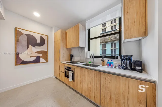 a kitchen with stainless steel appliances a stove a sink and a refrigerator
