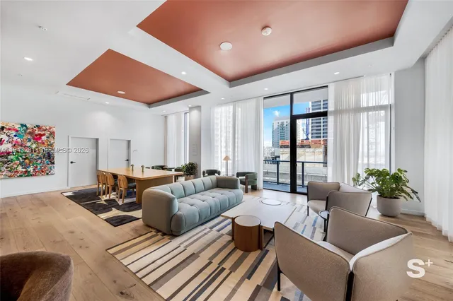 a living room with furniture and flowers