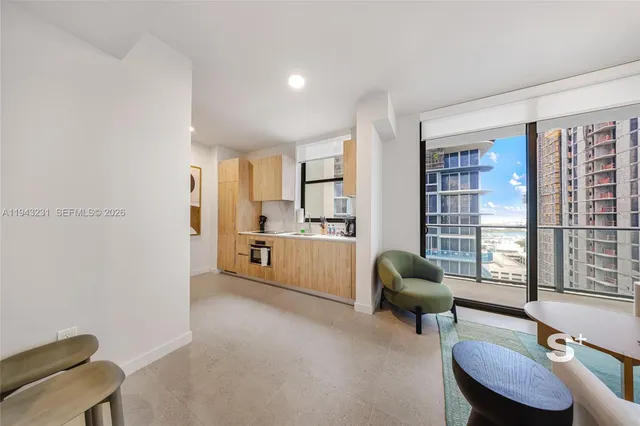 a living room with furniture and a large window