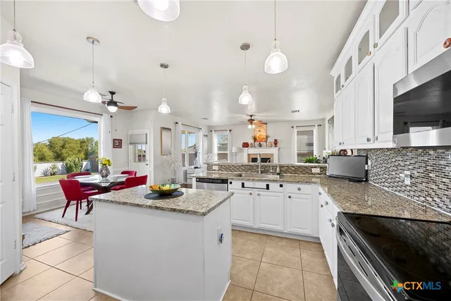 a kitchen with a sink stove and cabinets