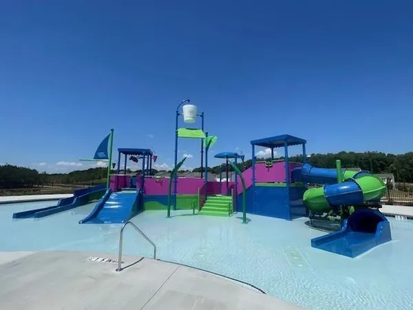 a childrens park with lots of swings and slides