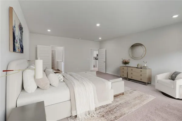 a bedroom with bed and a couch