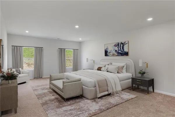 a spacious bedroom with a large bed and a couch