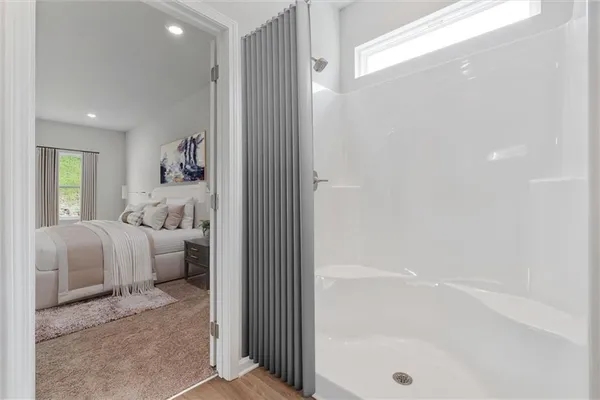a en suite bathroom with a tub shower and window