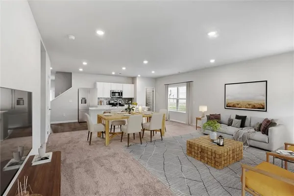 a living room with furniture kitchen view and a large window