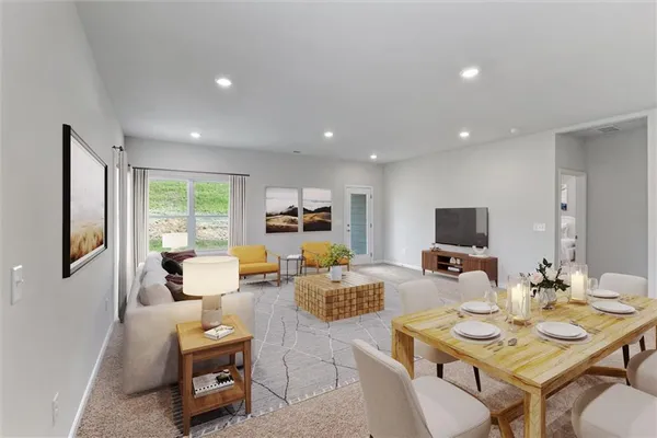 a living room with furniture kitchen view and a large window