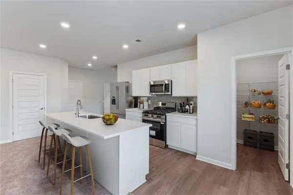 a kitchen with a stove a sink and a refrigerator