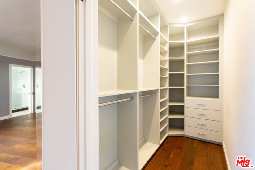 153 North Arnaz Drive Beverly Hills, CA 90211 - Photo 15 of 20 a view of walk in closet with empty racks