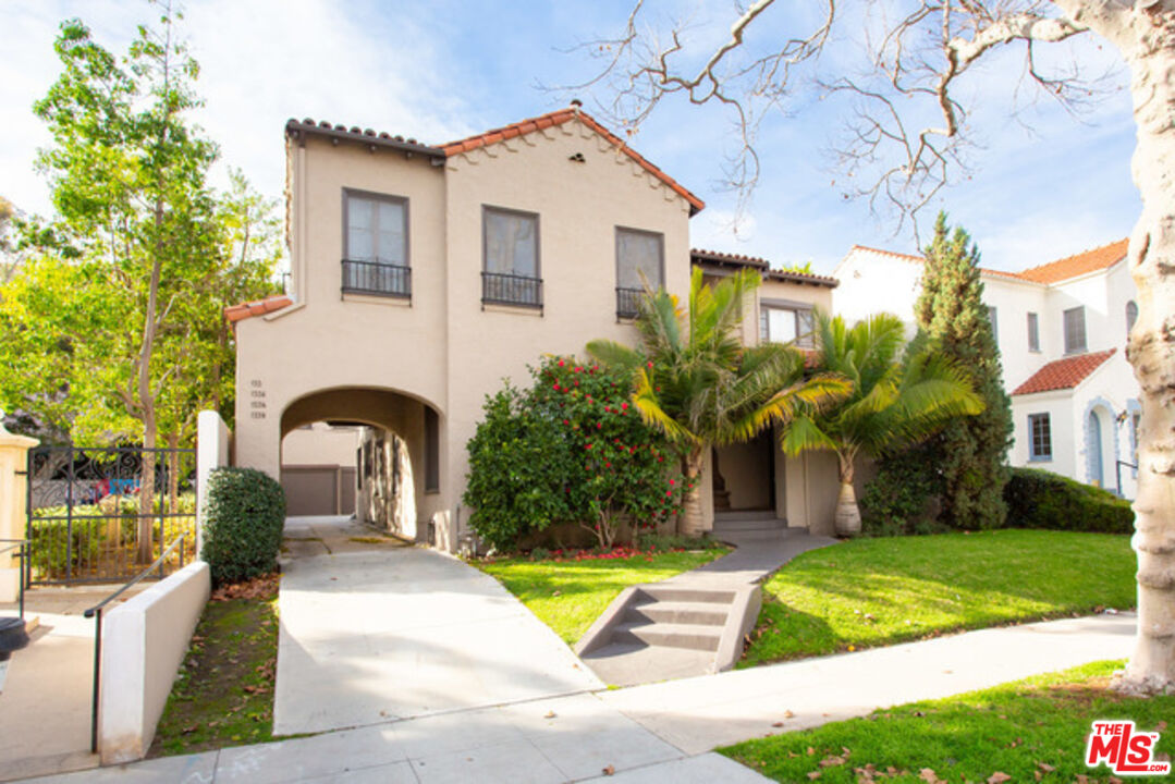 153 North Arnaz Drive Beverly Hills, CA 90211 - Photo 2 of 20 a front view of a house with garden