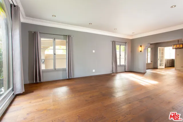 a view of a livingroom with wooden floor and a window
