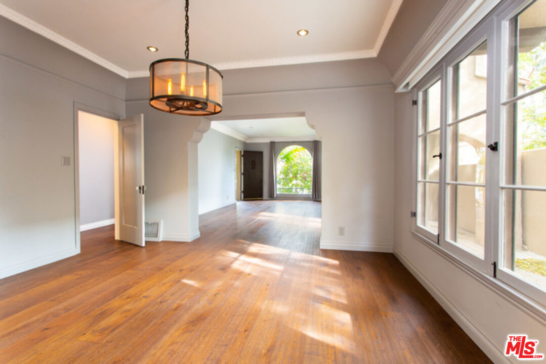 153 North Arnaz Drive Beverly Hills, CA 90211 - Photo 6 of 20 a view of empty room with wooden floor and fan