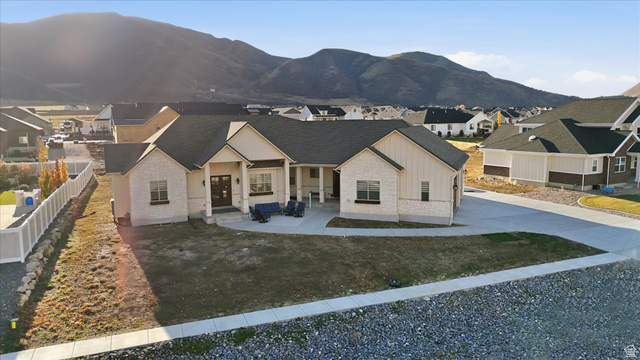 534 East Fish Hatchery Road Mantua, UT 84324 - Photo 77 of 87 View of front facade with stone siding, a residential view, covered porch, board and batten siding, and a mountain view